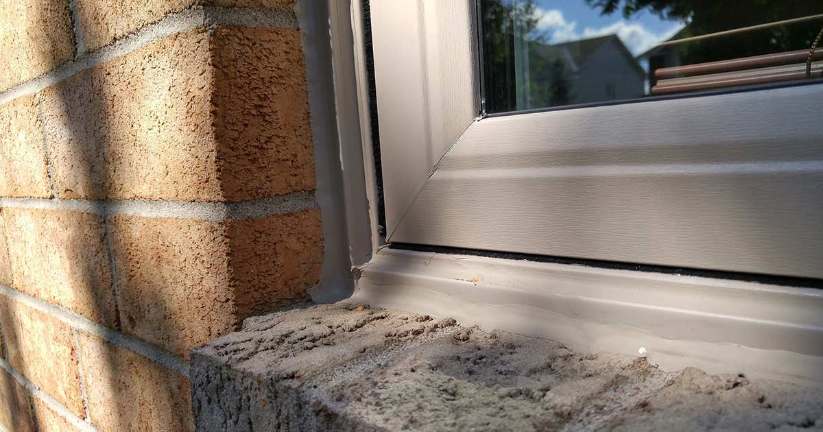 An image showing a sashed window with a brick mould installation 