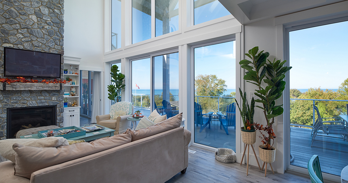 Image of modern living area with sliding patio doors and large windows 